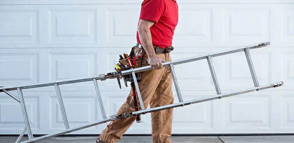 Garage door repair technician arriving with tools and ladder in Tuscaloosa, AL