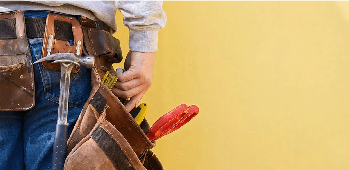 Handyman with tool belt ready for home repairs and maintenance in Tuscaloosa, AL