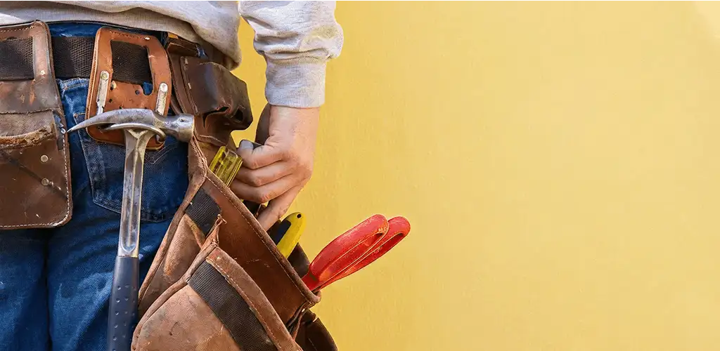 Handyman with tool belt ready for home repairs and maintenance in Tuscaloosa, AL