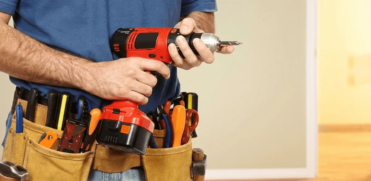 Handyman holding a power drill for home repairs and installations in Tuscaloosa, AL