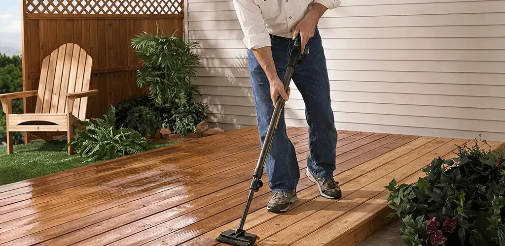Deck staining service applying stain to a backyard wood deck in Tuscaloosa, AL